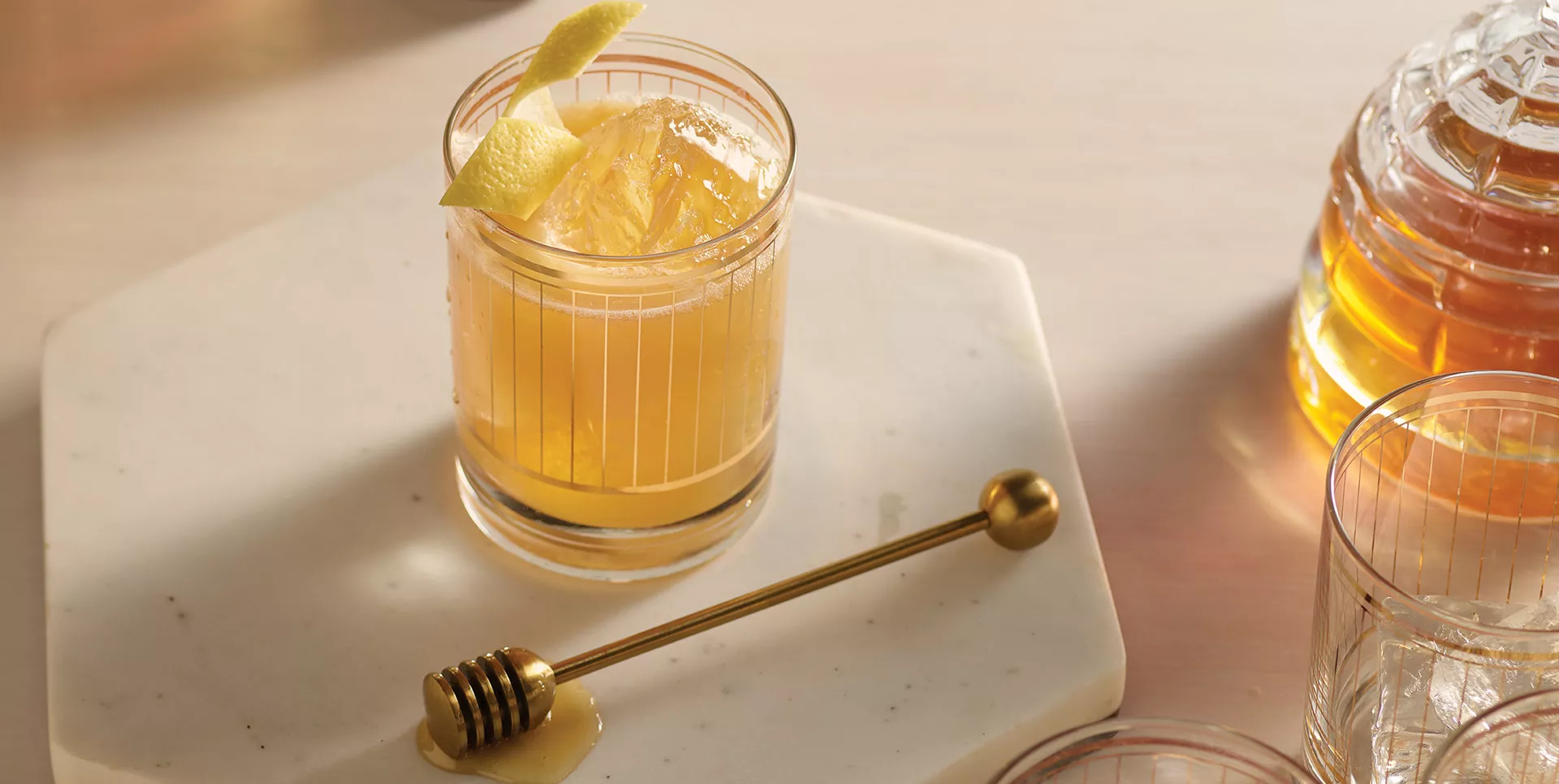 Gold rush cocktail on table with stirring spoon